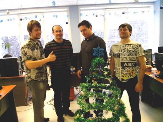Our super team of developers poses with the newly designed Christmas tree